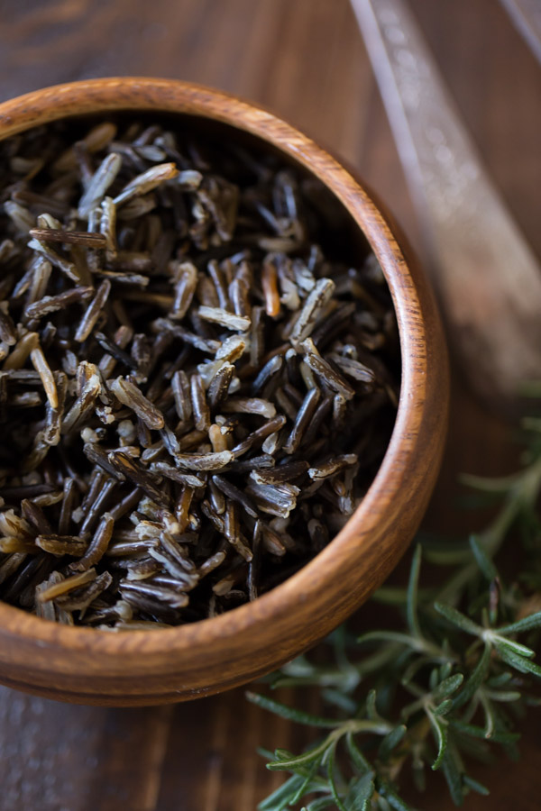 A small wood bowl of wild rice.  