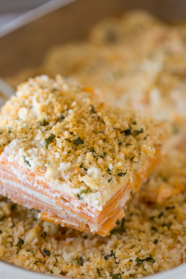 A serving of the Smoked Chili Sweet Potato Gratin being taken from the baking dish.  