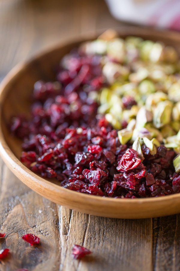 Chopped Cranberries and Pistachios in a wood bowl.  