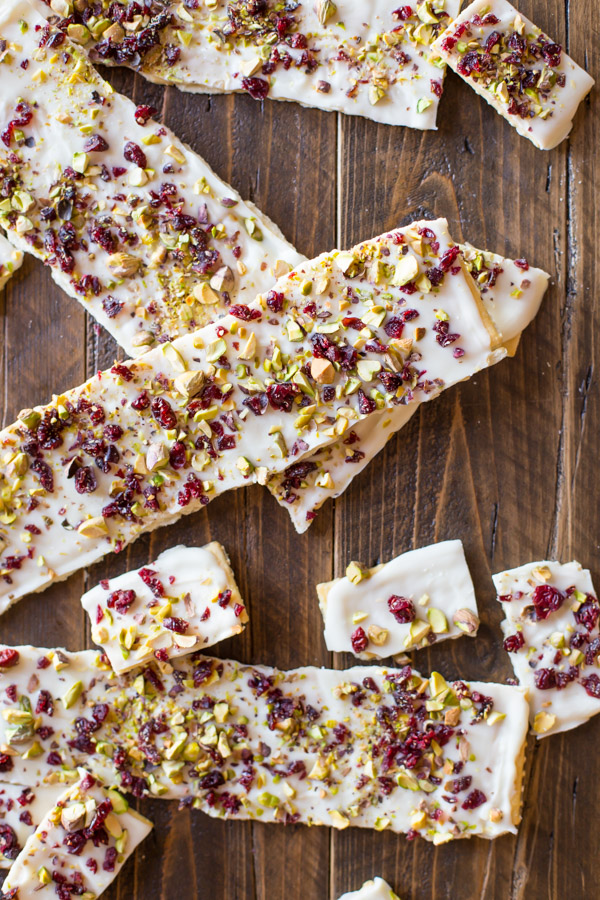 Cranberry Pistachio Butter Cracker Bark - A thin layer of white chocolate on a flaky buttery cracker with a sprinkle of dried cranberries and pistachios.