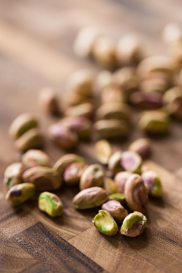 Shelled pistachios on a cutting board.  