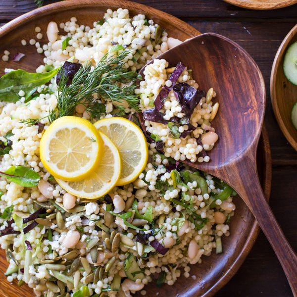 White Bean Couscous Salad With Lemon Vinaigrette - Baby greens, Israeli couscous, feta, dill, white beans, cucumber and pepitas make this salad light, fresh and healthy!