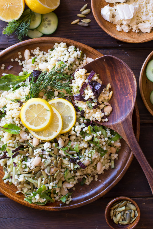 White Bean Couscous Salad With Lemon Vinaigrette - Baby greens, Israeli couscous, feta, dill, white beans, cucumber and pepitas make this salad light, fresh and healthy!