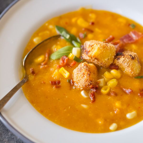 Butternut Squash Corn Chowder With Goat Cheese Croutons - A wonderfully balanced recipe with sweet corn, smokey bacon, chipotle peppers, and creamy goat cheese. Everyone will want to go back for more!