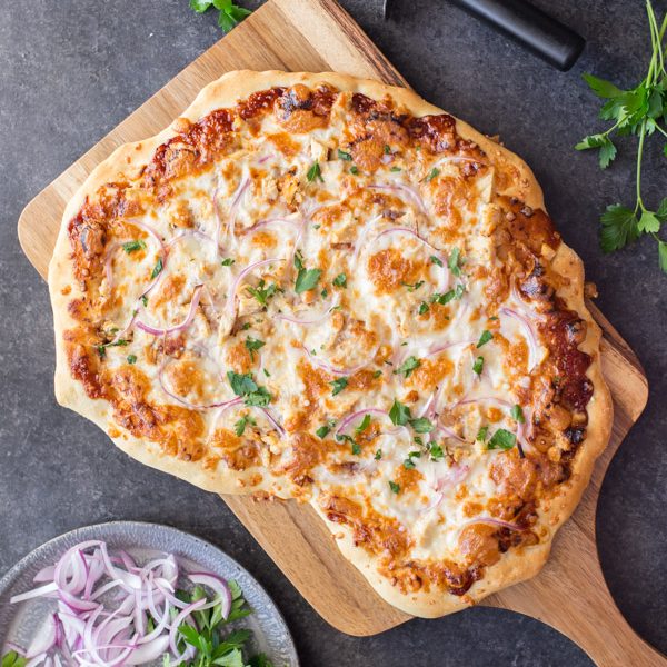Barbeque Chicken Pizza - Homemade pizza dough topped with barbecue sauce, grilled chicken, mozzarella cheese and red onions. A family favorite!