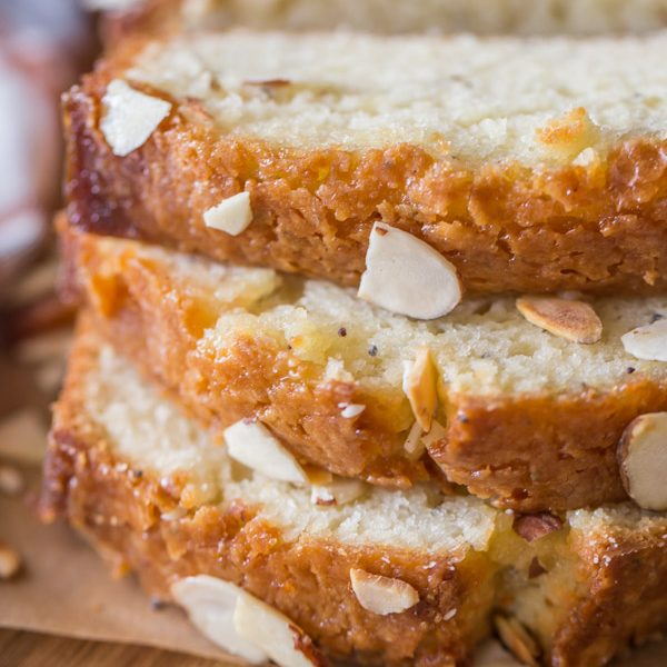 Glazed Almond Poppy Seed Bread - This quick bread is so moist and full of flavor. The orange almond glaze makes it irresistible!