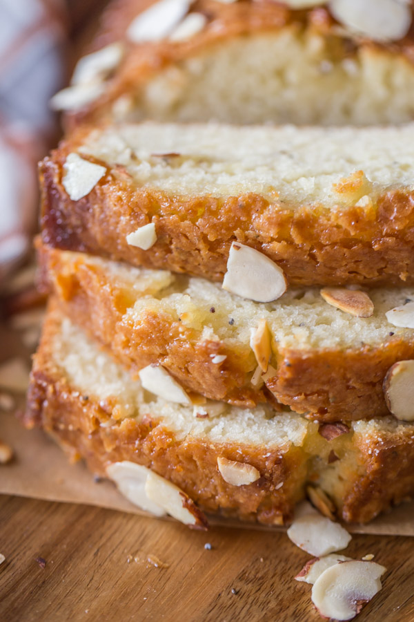 Glazed Almond Poppy Seed Bread - This quick bread is so moist and full of flavor. The orange almond glaze makes it irresistible!