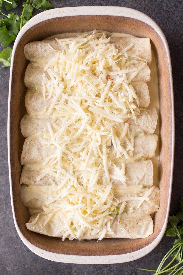 Hatch Green Chile Chicken Enchiladas in a baking dish before baking.