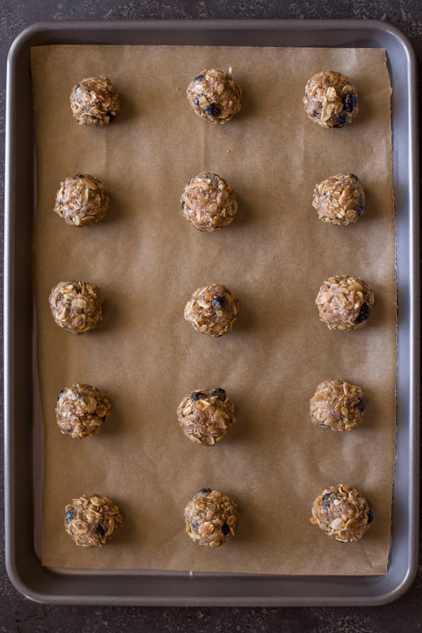 Blueberry Muffin Energy Bites on a parchment paper lined baking sheet.