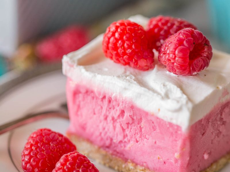 A gorgeous raspberry sherbet dessert with a pretzel crust and a homemade whipped topping! Perfect for summertime get togethers!