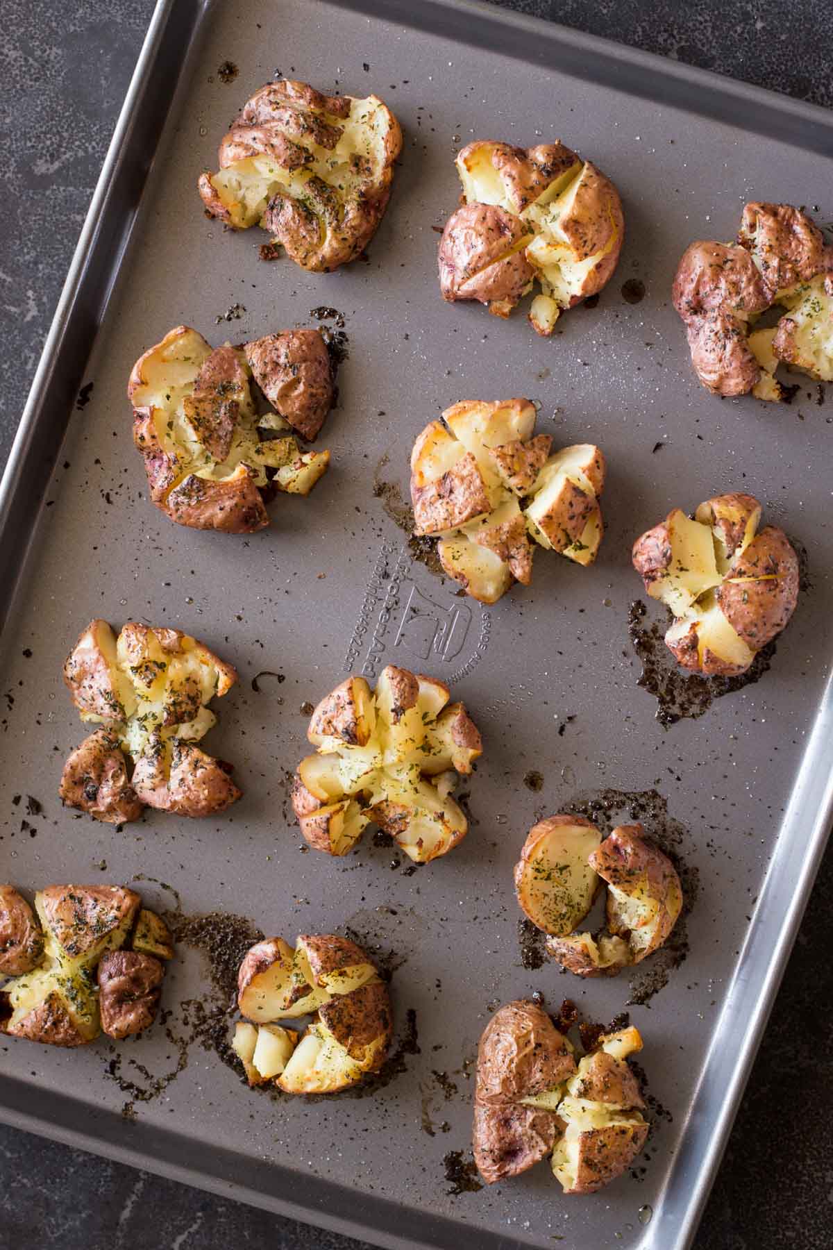 Smashed and Roasted Parmesan Potatoes on a baking sheet. 
