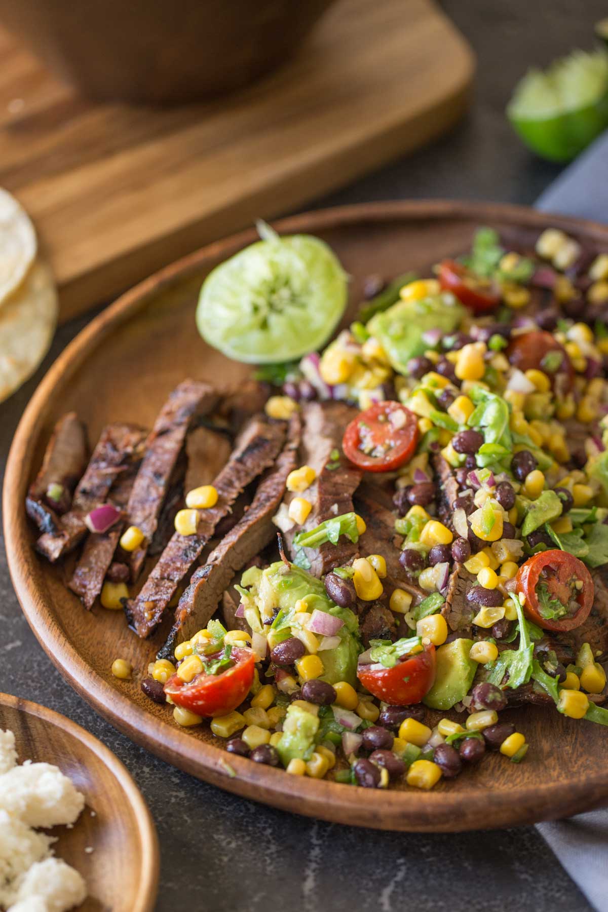 Grilled, marinated flank steak sliced thinly, wrapped in a warm corn tortilla and topped with a fresh mixture of avocado, tomato, corn, and black beans!