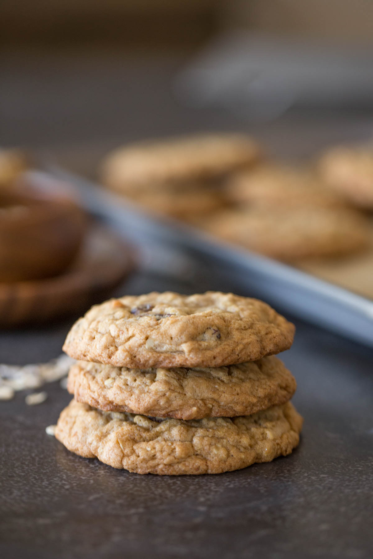 Three Bakery Style Oatmeal Raisin Cookies stacked on top of each other.  