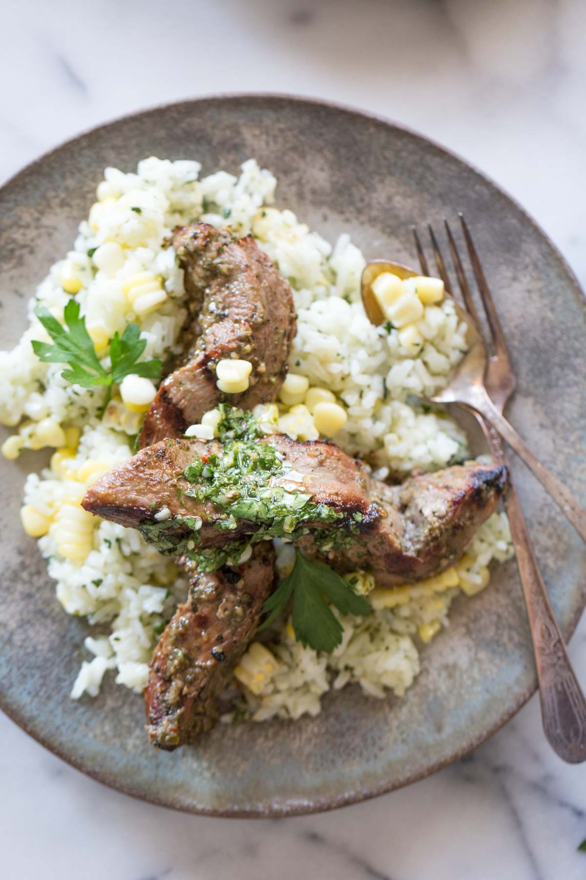 Celebrating all the bold flavors of Brazil with this recipe for marinated flank steak served over chimichurri rice!
