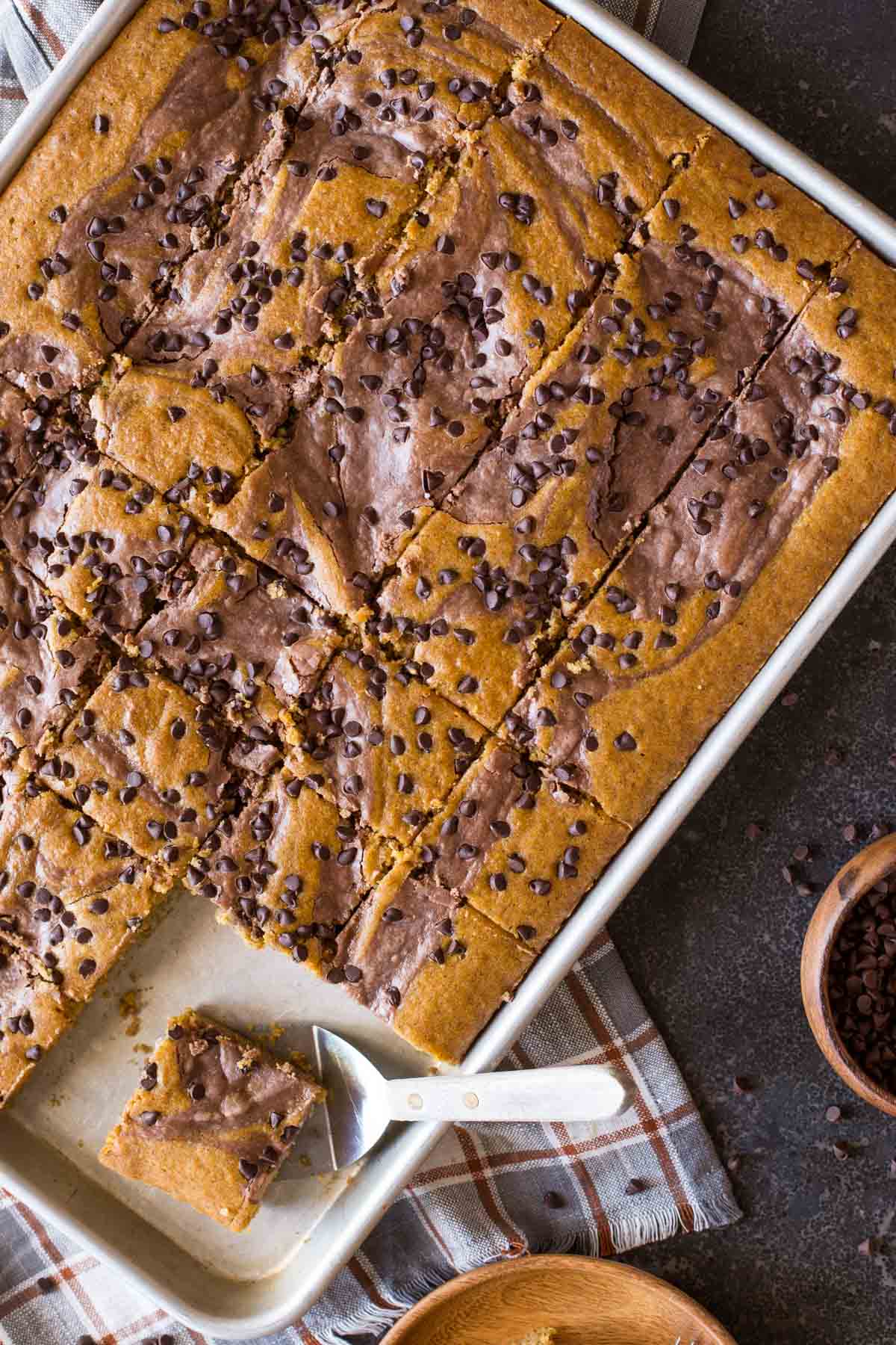 With plenty to feed a crowd, this pumpkin sheet cake with a chocolate cheesecake swirl is perfect for holiday gatherings!