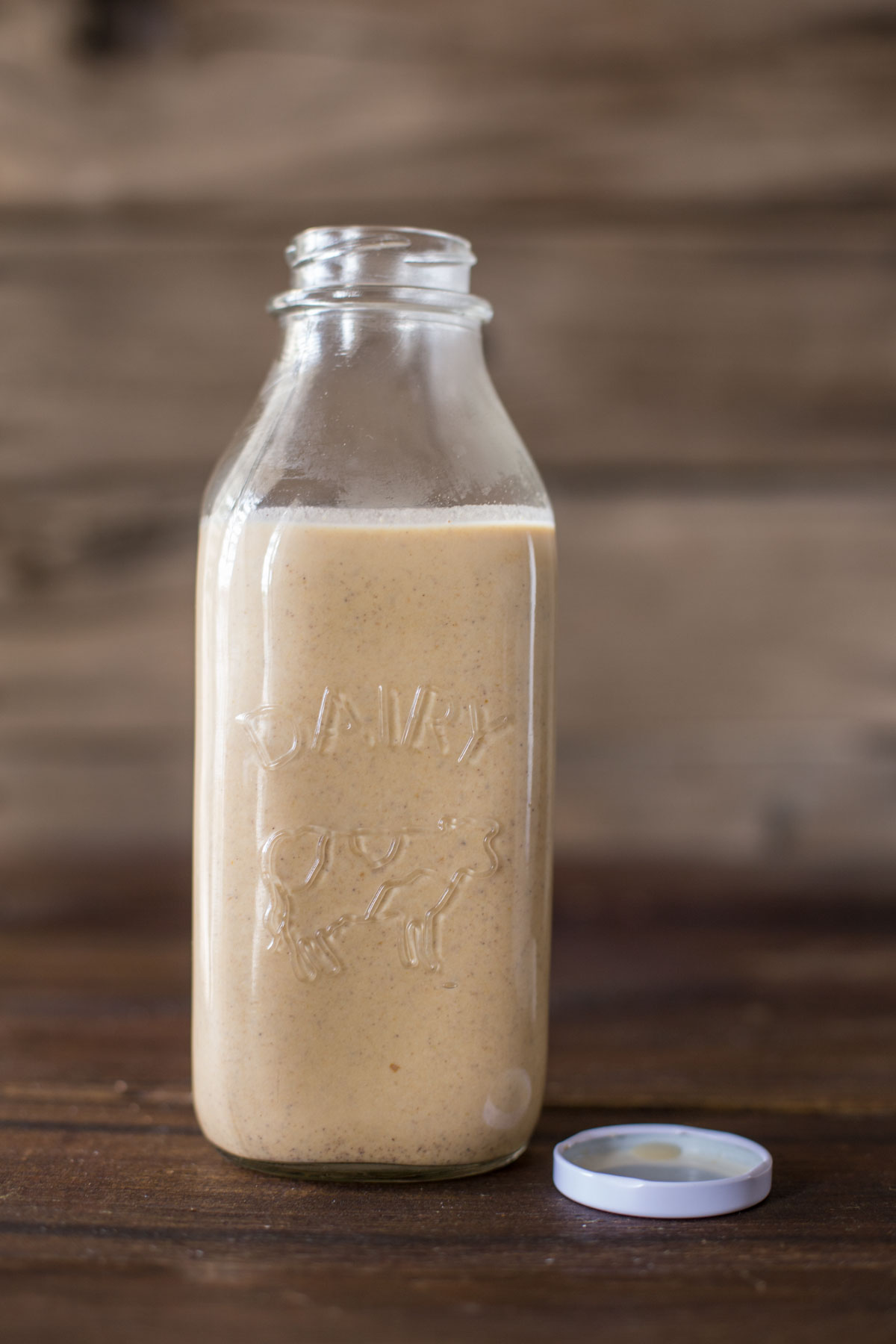 Homemade Pumpkin Spice Coffee Creamer in a glass jar.