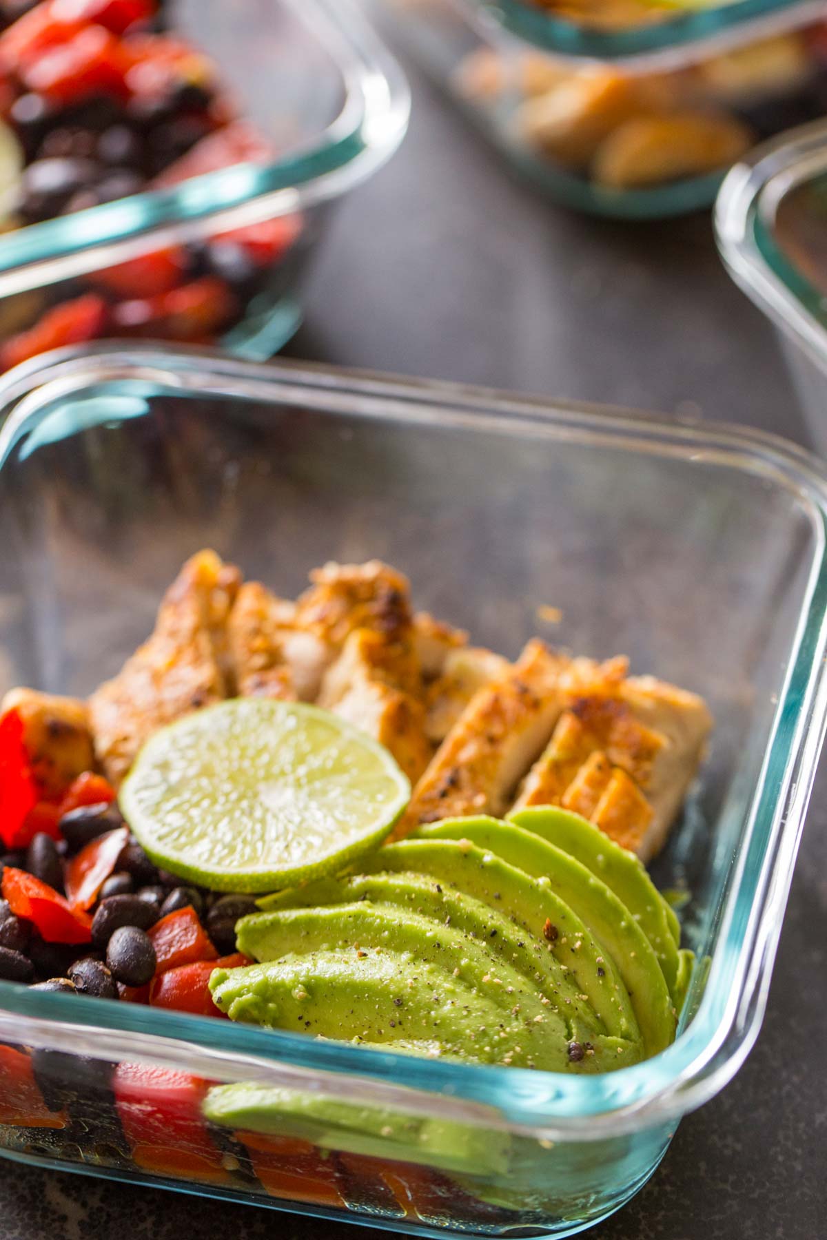  A Healthy Southwestern Chicken Bowl, topped with a slice of lime and some sliced avocado.  