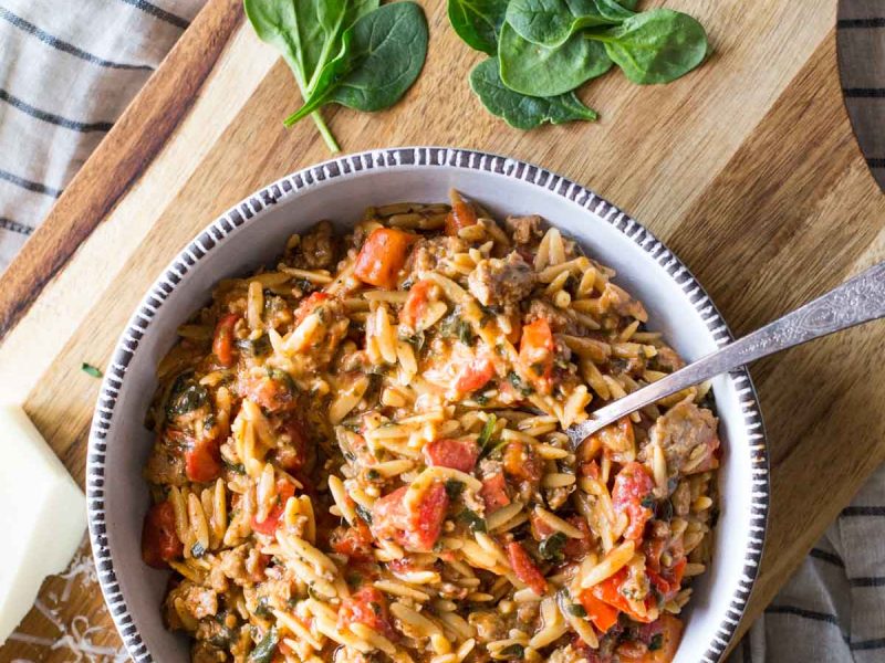 The whole family will love this One Pot Creamy Tomato Orzo made with turkey sausage, fire roasted tomatoes, red peppers, spinach, cheese and whole wheat pasta!