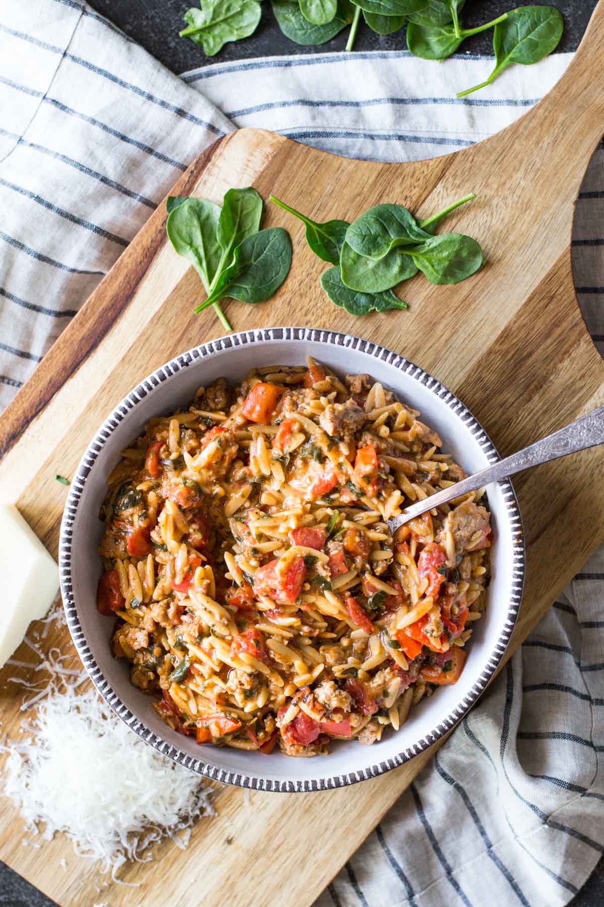 The whole family will love this One Pot Creamy Tomato Orzo made with turkey sausage, fire roasted tomatoes, red peppers, spinach, cheese and whole wheat pasta!