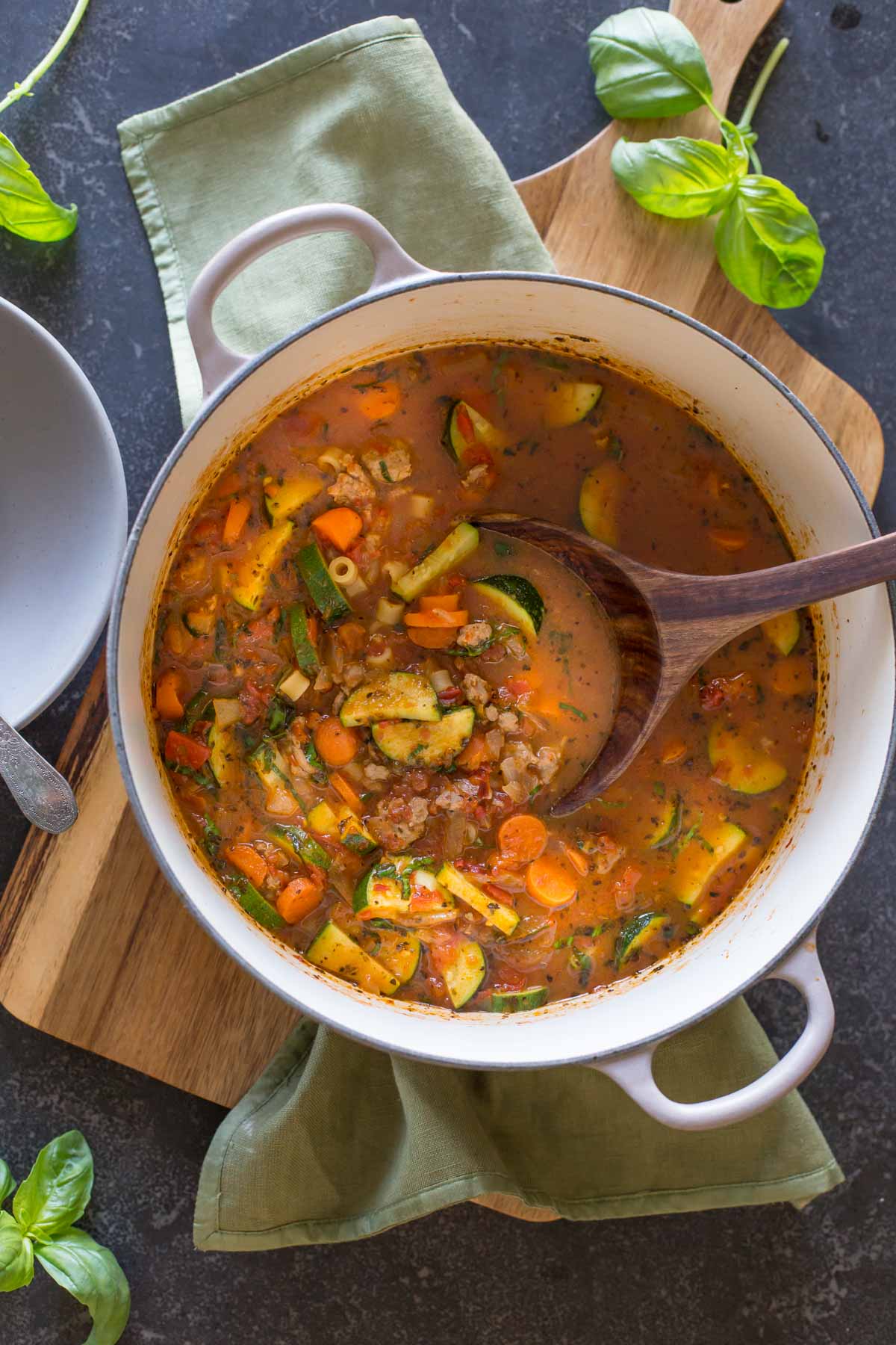 Turkey and Vegetable Ditalini Soup in a large pot with a wood serving spoon in it. 