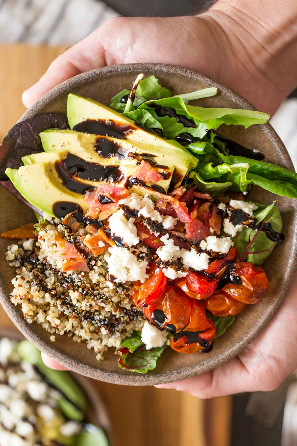 These BLT Bliss Bowls have so much going on! They've got mixed baby greens, oven roasted tomatoes, crisp bacon, avocado, nutty quinoa, and creamy feta.