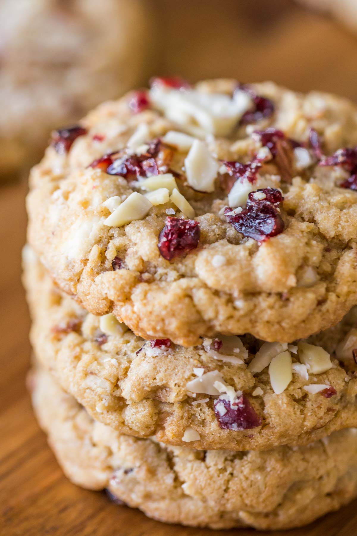 Cranberry Almond White Chocolate Chunk Cookies stacked in a pile of three.