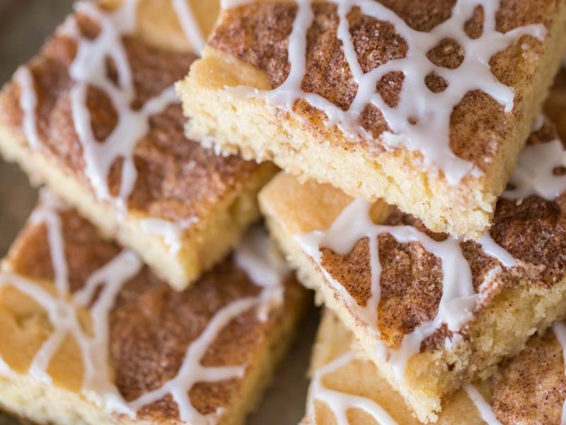 These Snickerdoodle Bars taste just like the classic cookies we all love, but come together much more quickly and are topped with a delicious vanilla glaze!