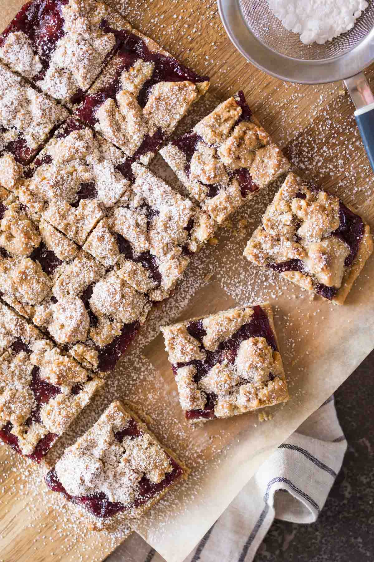 Peanut Butter and Jelly Oat Bars cut into squares and dusted with powdered sugar. 
