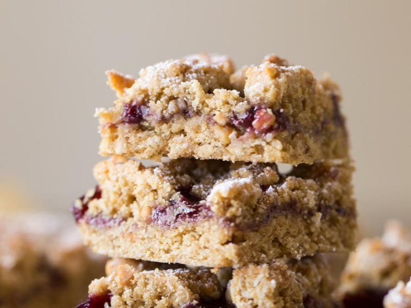 These Peanut Butter and Jelly Oat Bars have a soft peanut butter cookie base, mixed berry preserves, and more crumbled peanut butter cookie dough!