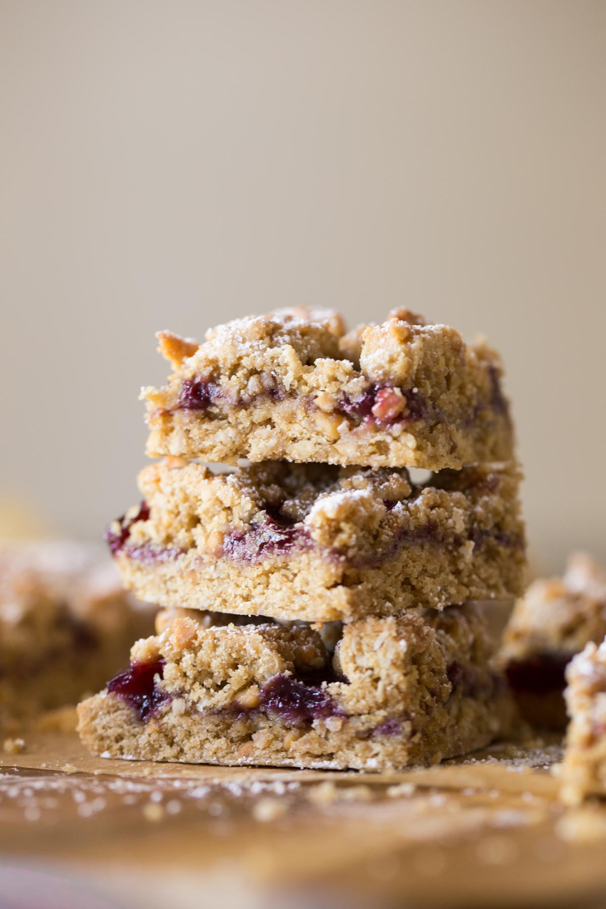 These Peanut Butter and Jelly Oat Bars have a soft peanut butter cookie base, mixed berry preserves, and more crumbled peanut butter cookie dough!