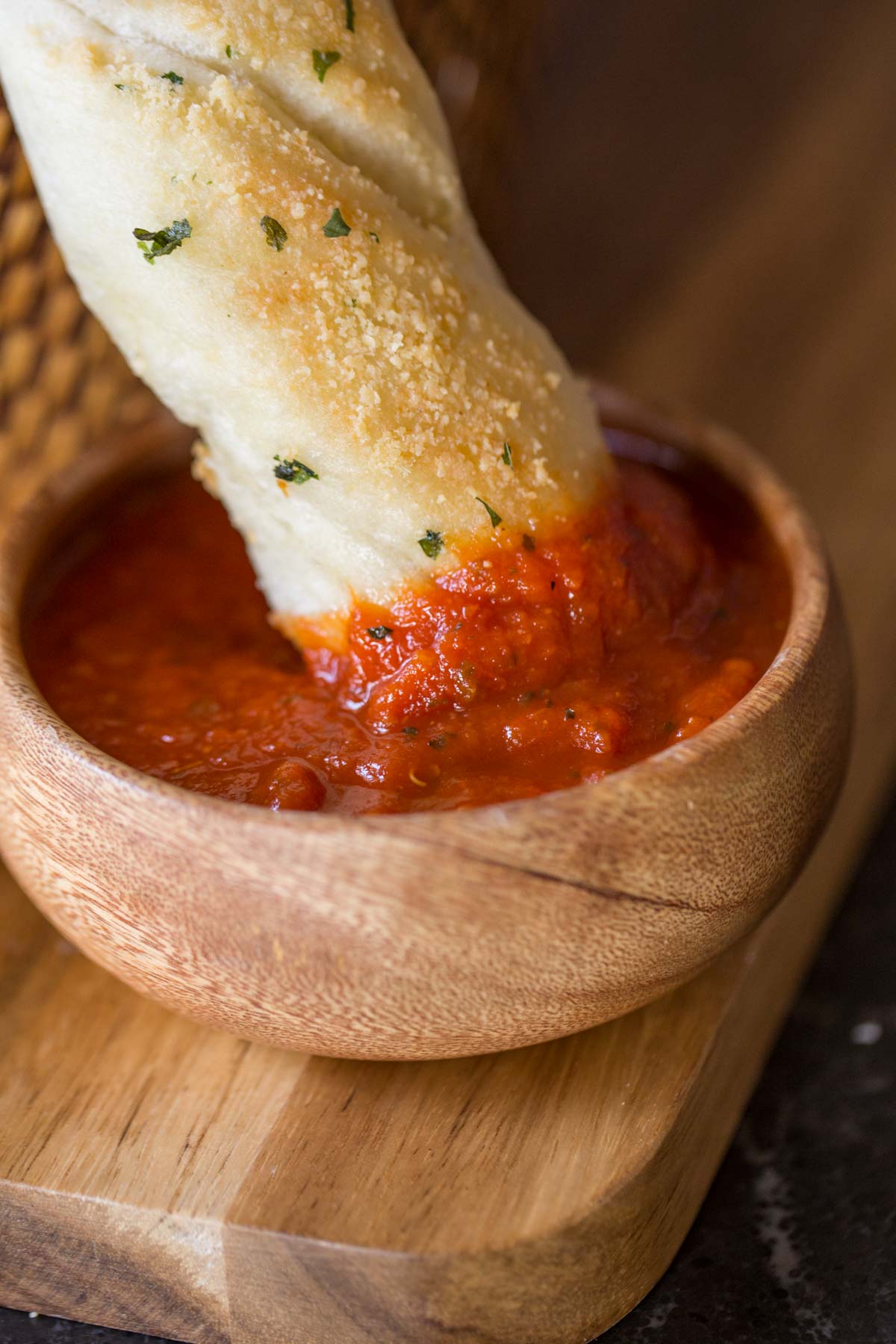 Fresh Buttery Garlic Breadsticks dipped in marinara.