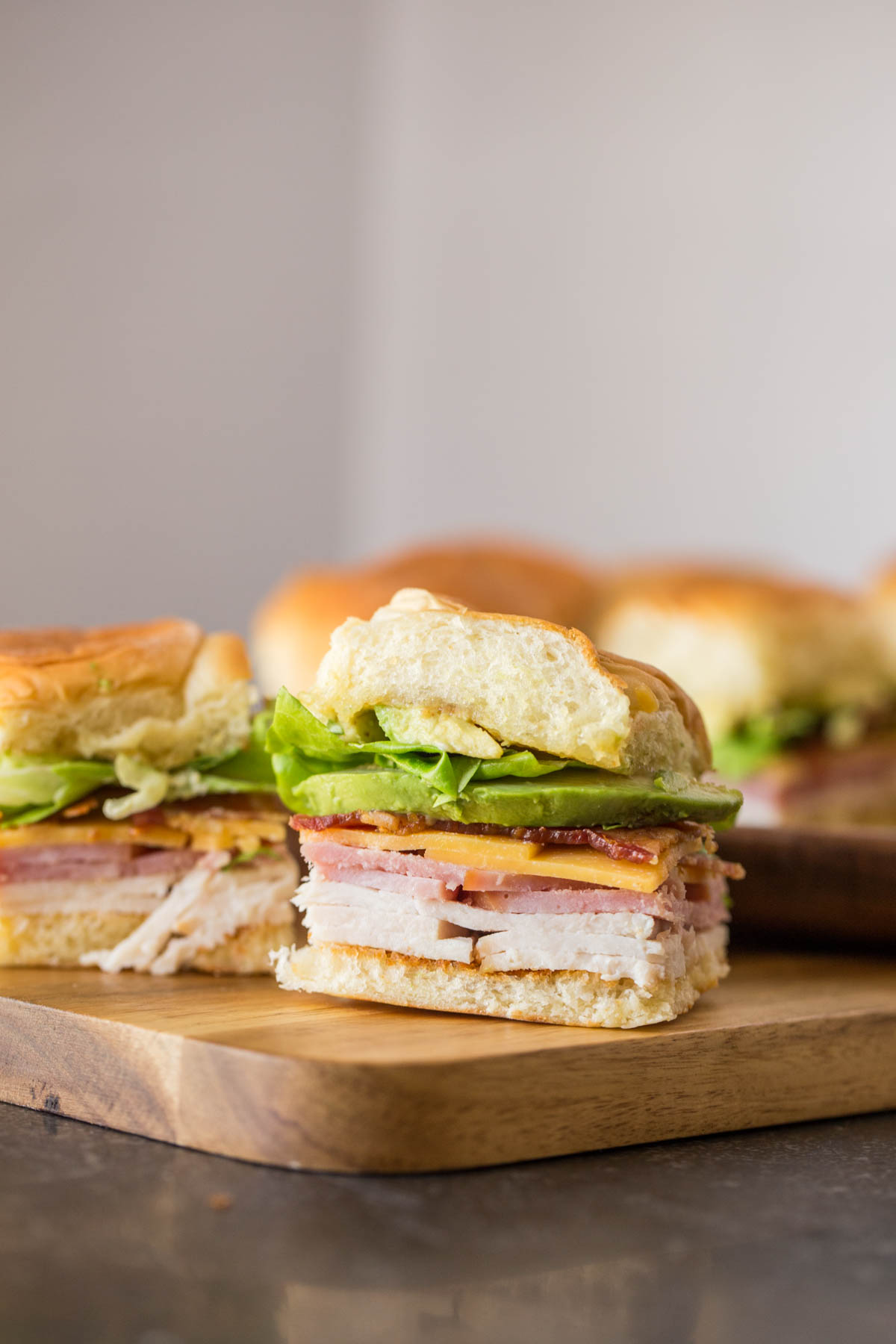 Ultimate Club Sandwiches for a Crowd on a cutting board.