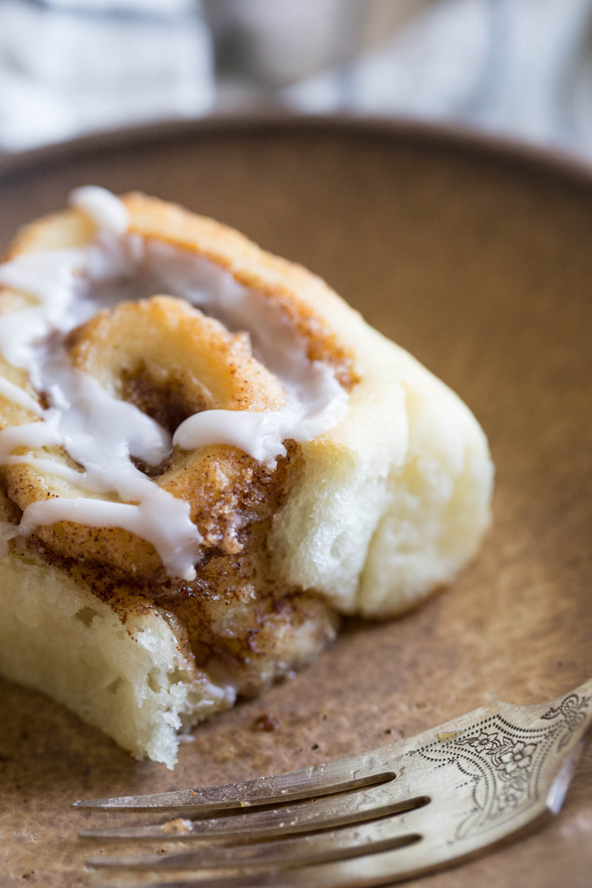 Sheet Pan Cinnamon Roll on a plate with a fork.