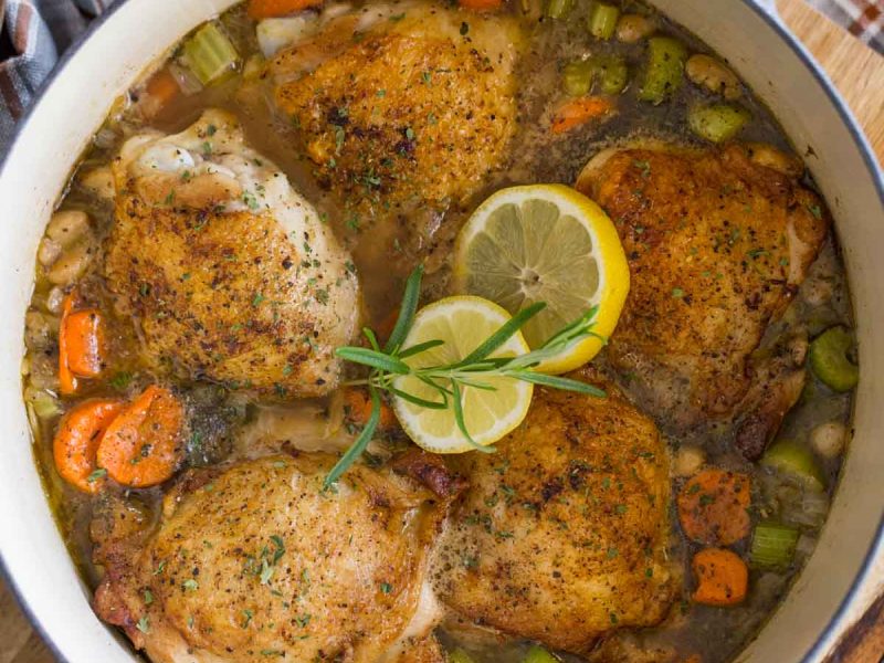 This rustic lemon rosemary chicken dish with orzo, white beans and vegetables comes together with layers of flavor in one dutch oven in about an hour.