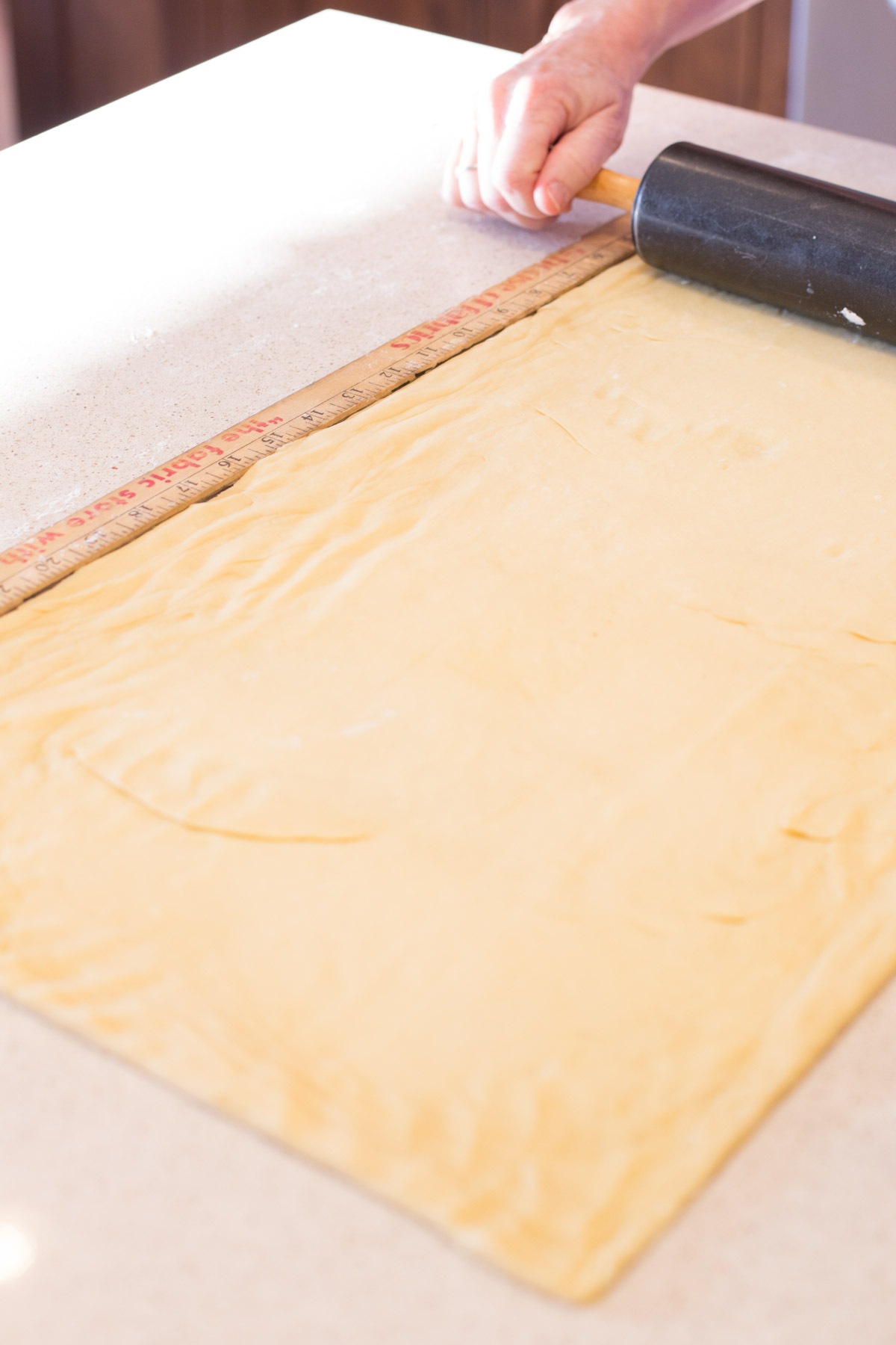 Dough for the Buttery Almond Bear Claws being rolled into a rectangle.