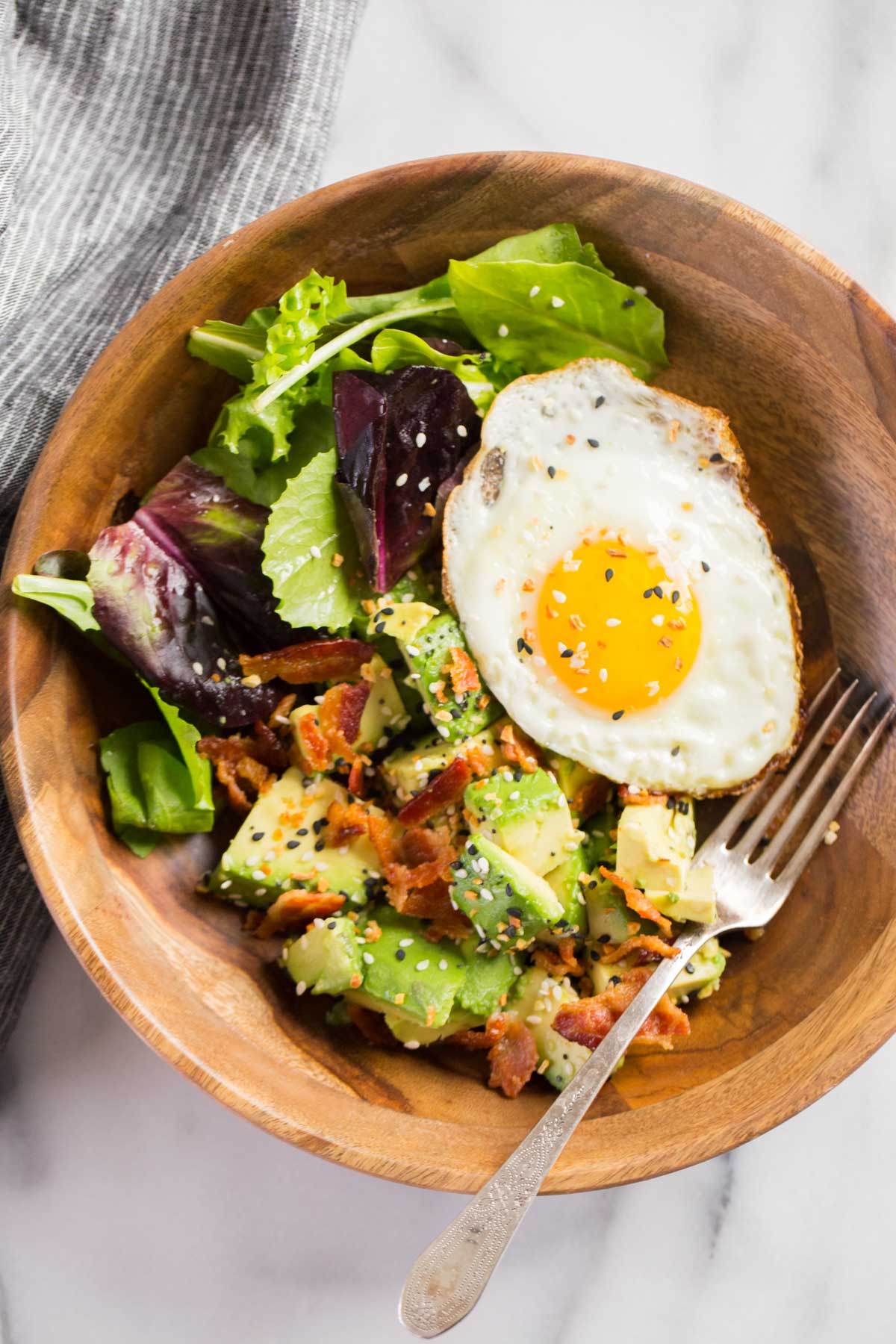 We've got creamy avocado and baby greens dressed with freshly squeezed lemon juice and sprinkled with crispy bacon and Everything But the Bagel Seasoning. Start your morning off right!