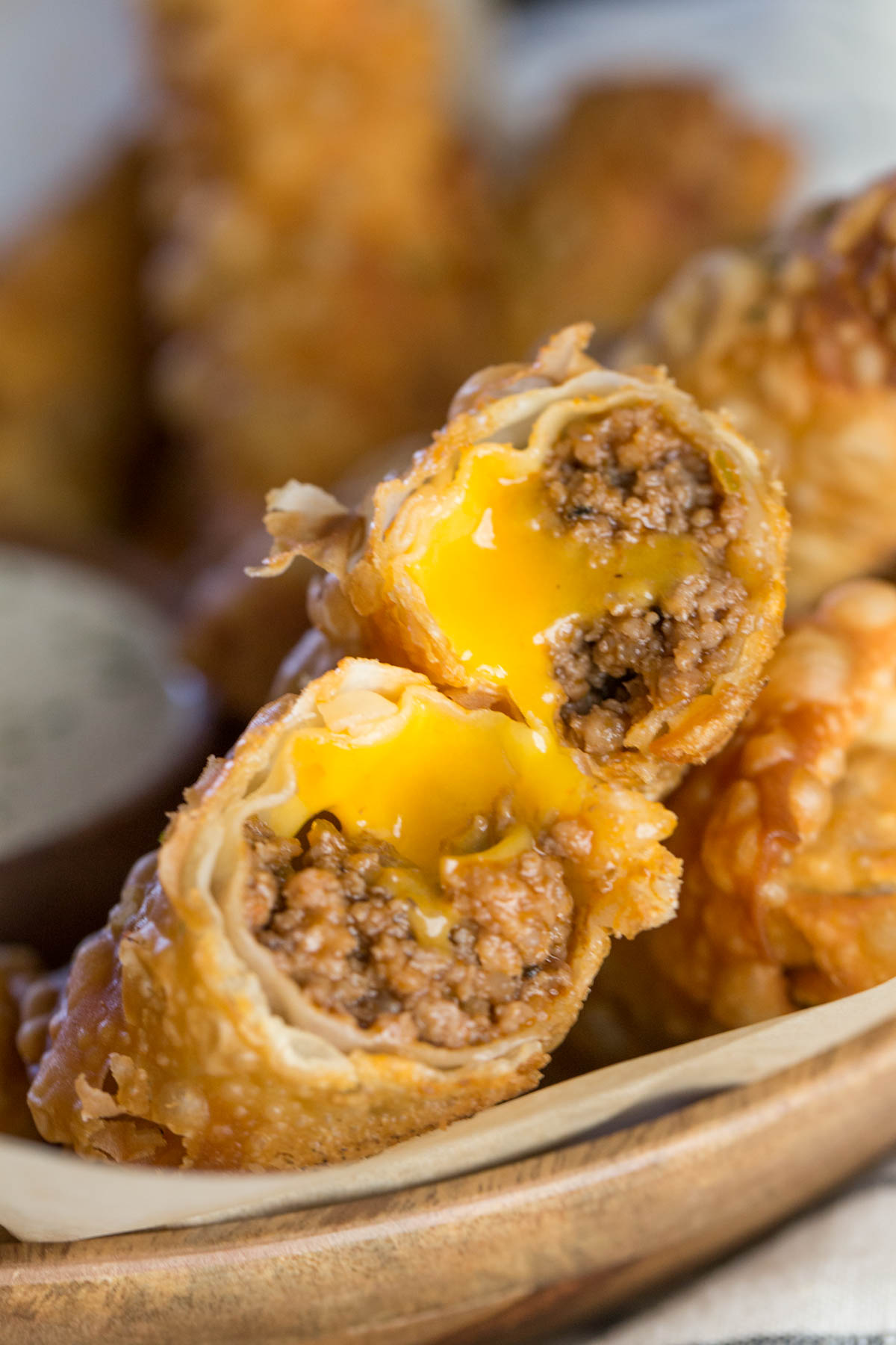 A Fried Sloppy Joe Roll that has been broken in half, showing the meat and cheese filling. 