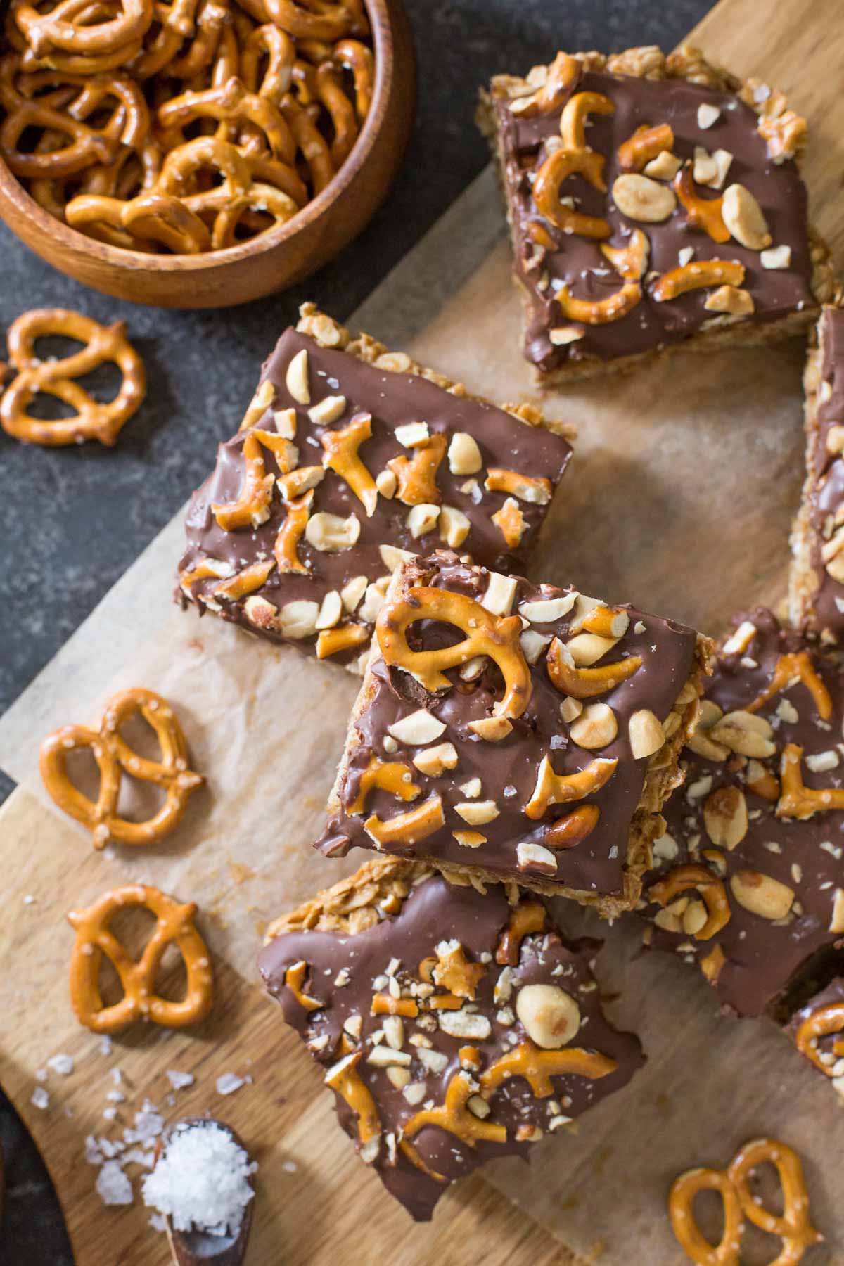 A top down view of cut Oh Henry Bars with pretzels and sea salt scattered around