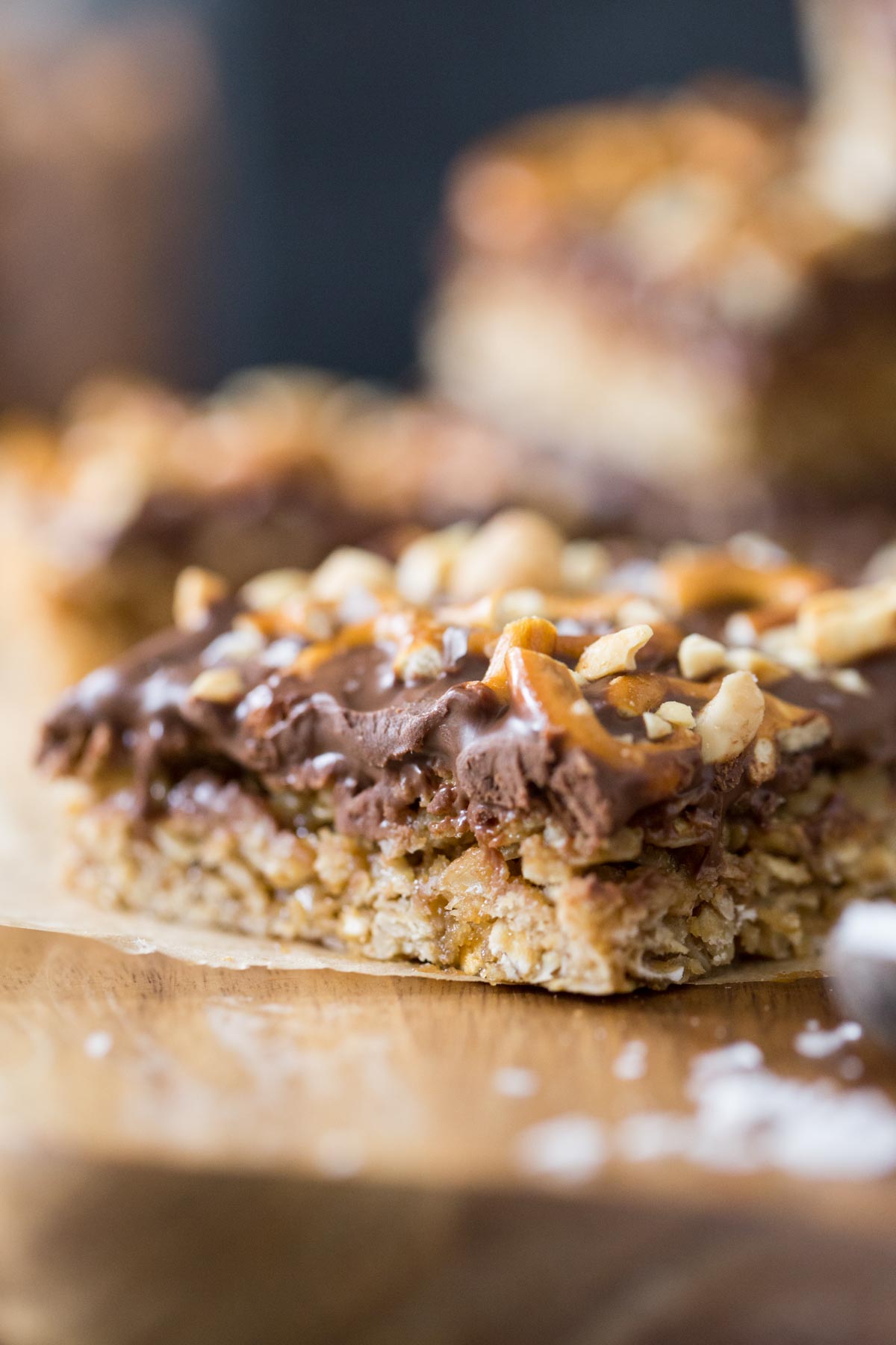 A close up view of the oatmeal and peanut butter chocolate layer of an Oh Henry Bar from the side view