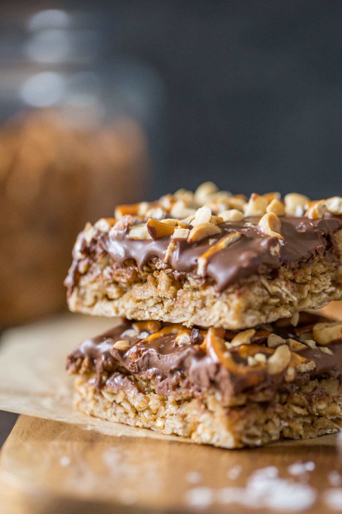 A side view of the chewy oat layer and chocolate peanut butter layer of two stacked Oh Henry Bars