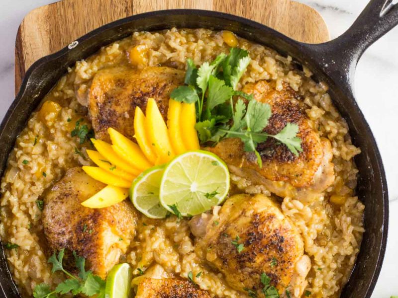 We've got crispy chicken cooked on the bone so it stays nice and juicy, and creamy rice with lots of onions, garlic, chili powder, and lime.  Serve it with fresh slices of mango, lots of cilantro and freshly squeezed lime juice.