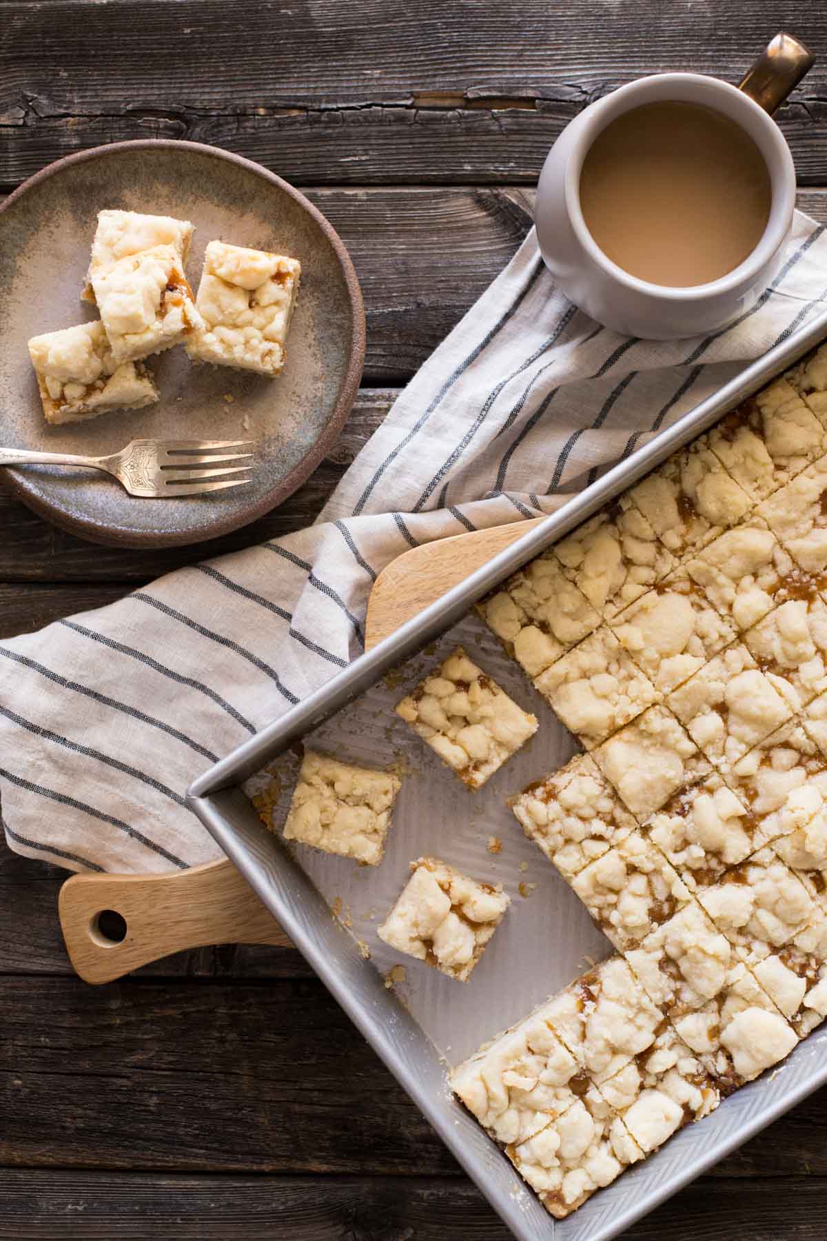 Overhead shot of Buttery Salted Caramel Bars on a wooden background. 