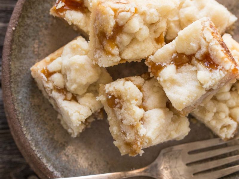 Close up overhead shot of Buttery Salted Caramel Bars on a green plate.