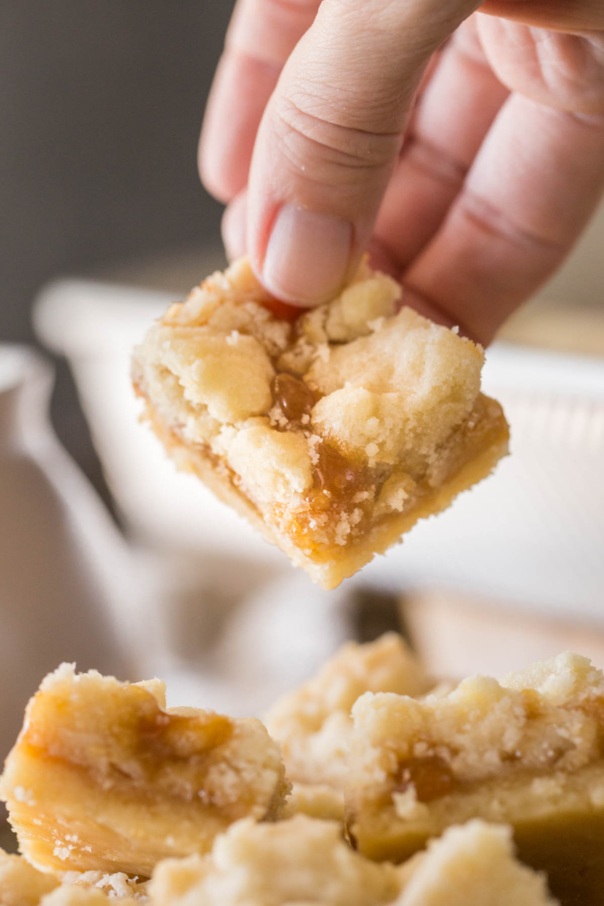 Buttery Salted Caramel Bar being lifted off a plate. 