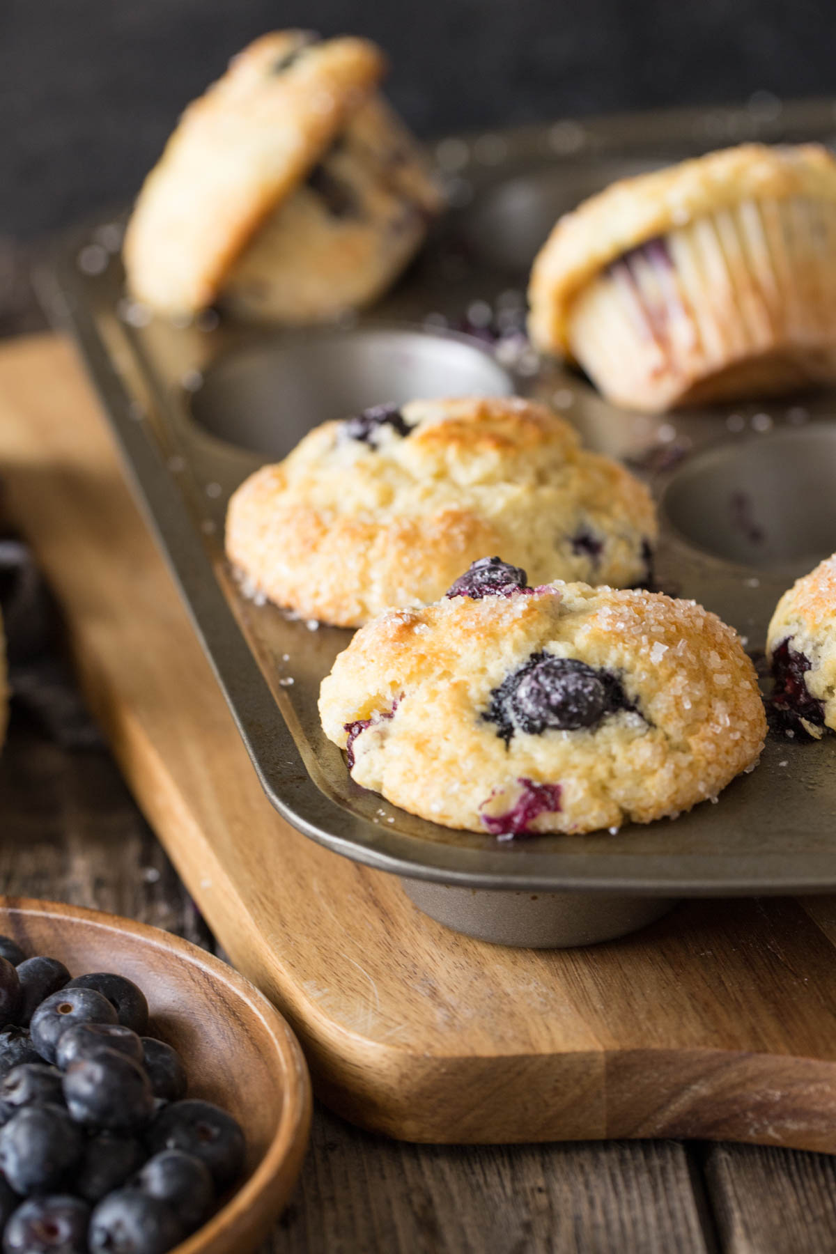 A close up view of Best Ever Buttermilk Blueberry Muffins in a muffin pan.