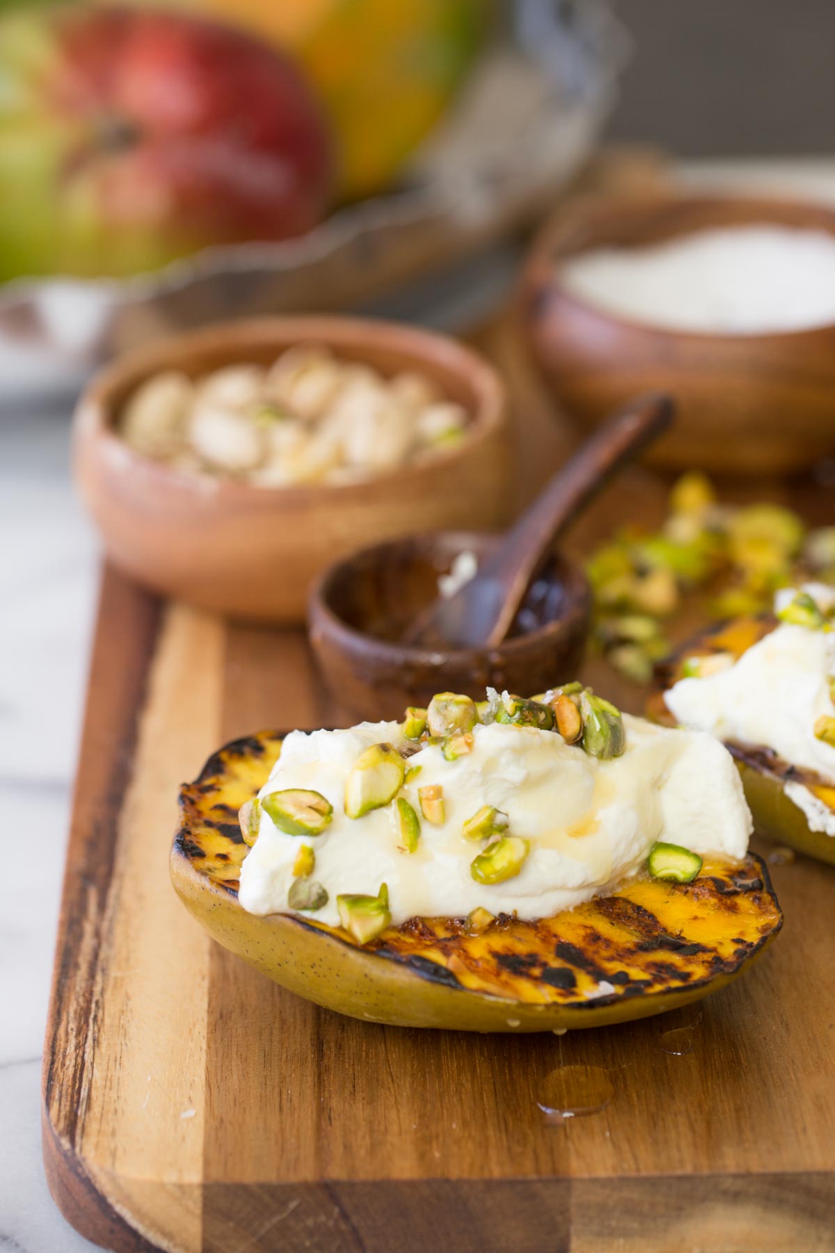 Wooden board with Grilled Mango With Honey Ricotta Whipped Cream