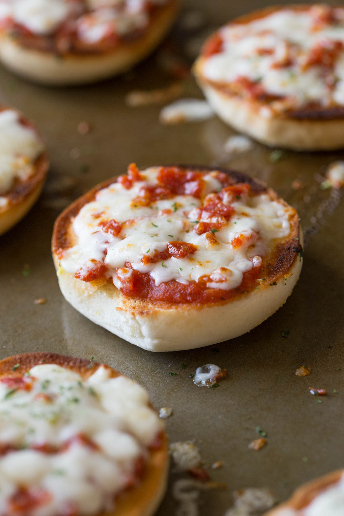 Close up of Homemade Mini Bagel Pizza on a baking sheet.
