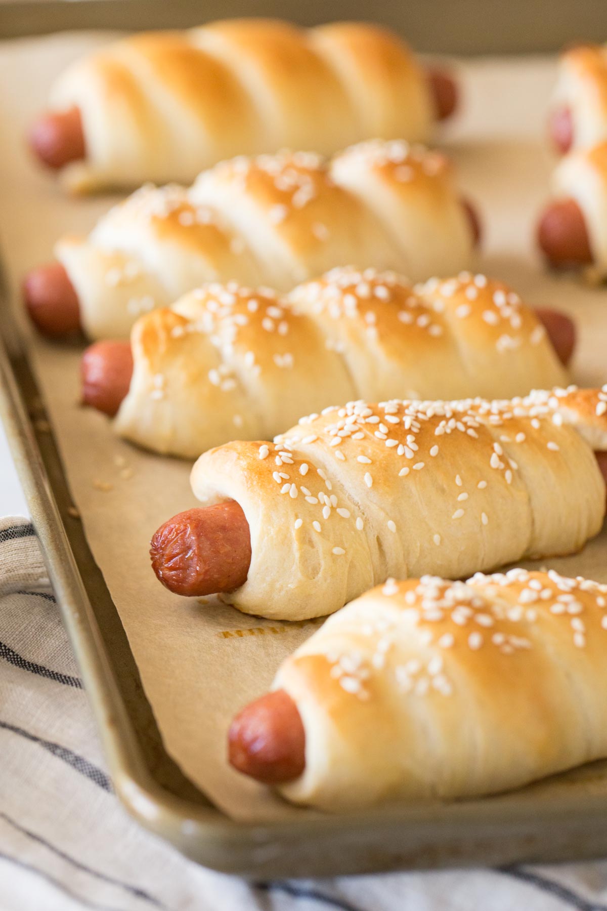 Homemade Pigs in a Blanket on a baking sheet.