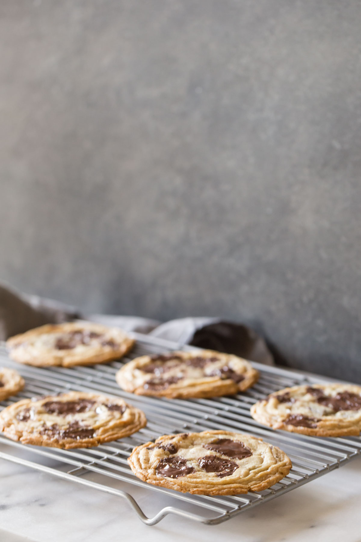 Toffee Almond Chocolate Chunk Cookies on a cooling rack. 
