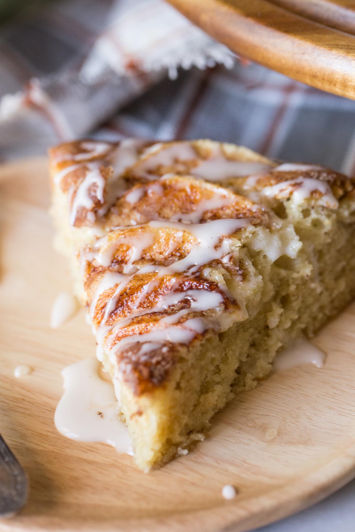 Close up shot of slice of Apple Cider Cake drizzled with glaze. 